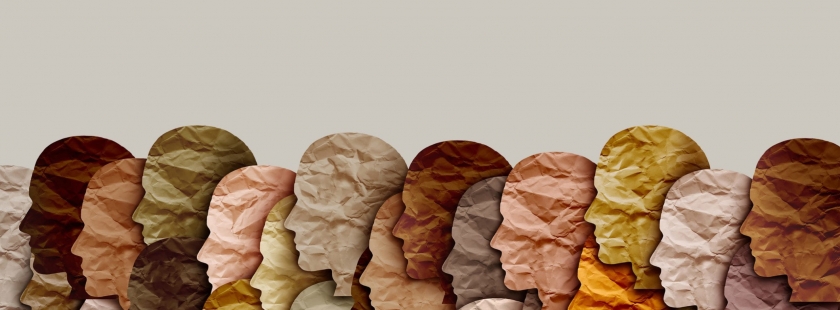 paper cut-out silhouettes of faces in a variety of skin-toned colors