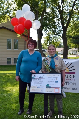 Pat Zietlow Miller and Helen Perkolup from Troup 747 & 47 standing in front of the permeant Story Walk. 